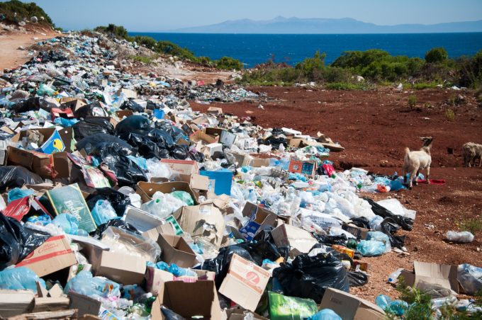 Waste piled up next to a river in Albania