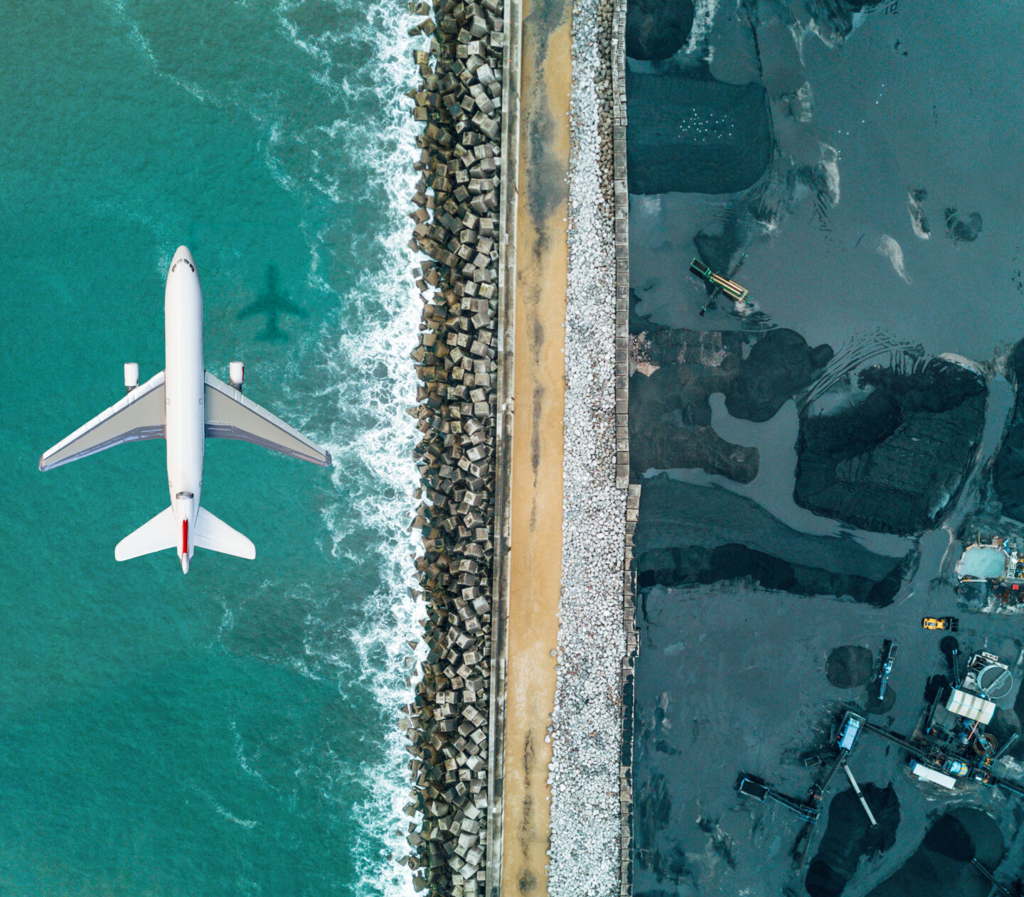 Airplane flying over a fossil fuels mine