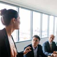 Young woman talking in a board meeting