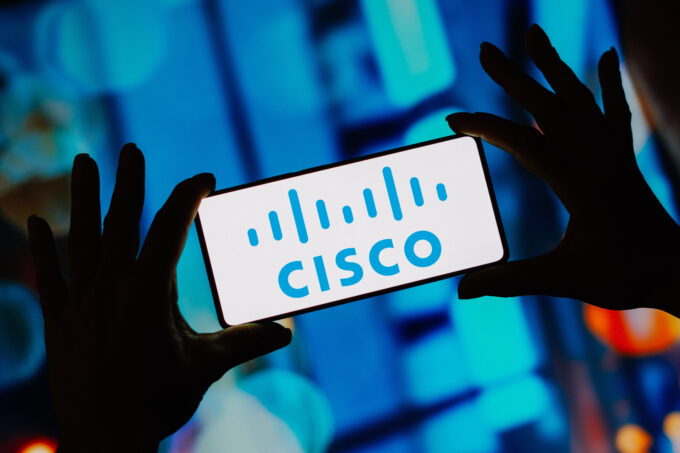 In this photo illustration, the Cisco Systems logo is displayed on a smartphone screen