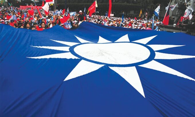 A large Kuomintang party flag is seen at a campaign rally on Jan 8, 2012 in Taipei.—AFP