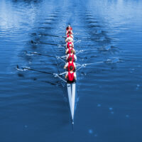 Boat coxed eight Rowers rowing on the blue lake Classic Blue Pa