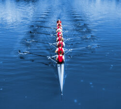 Boat coxed eight Rowers rowing on the blue lake Classic Blue Pa