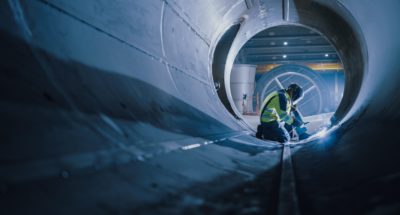 Welder welding in a massive pipe