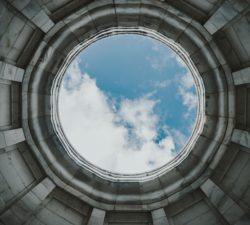 A round hole showing blue sky