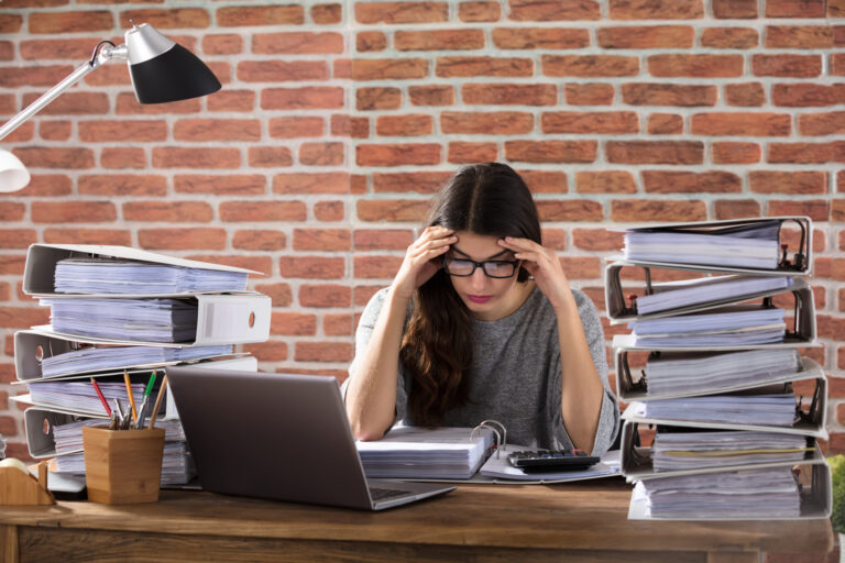 Tired Businesswoman Surrounded by work