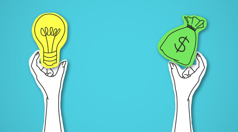 One hand holding green bag with money other light bulb