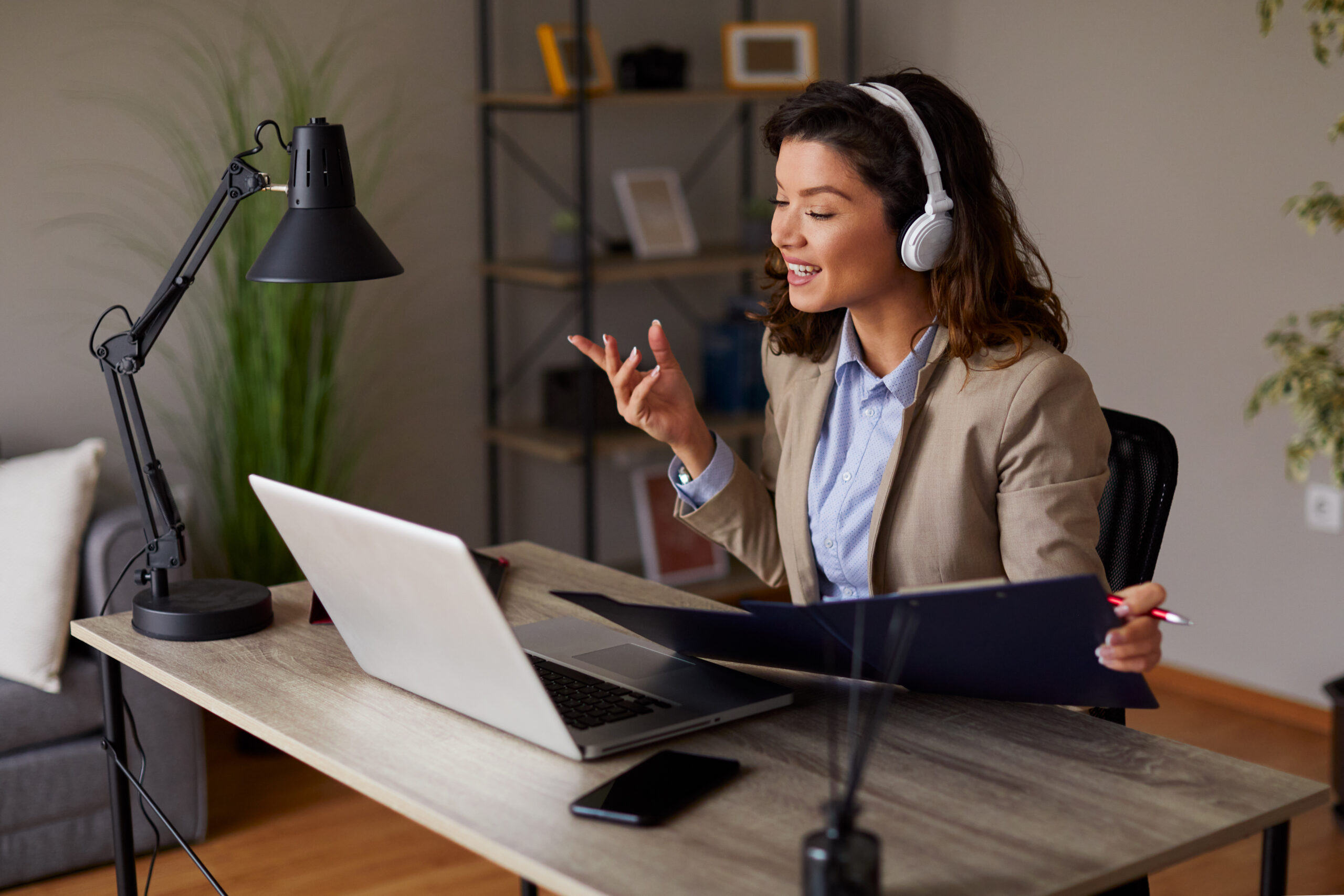 Young woman has a business conference via laptop