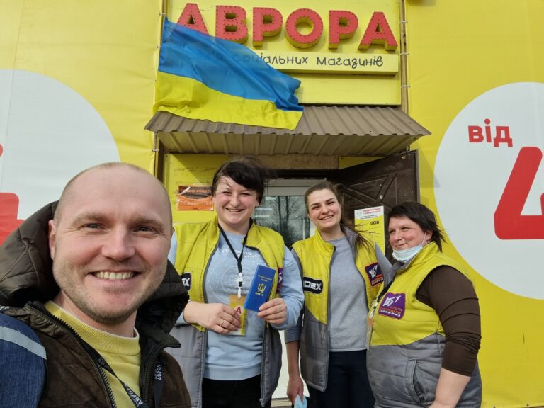 Taras Panasenko stands in front of an Avrora store in Ukraine