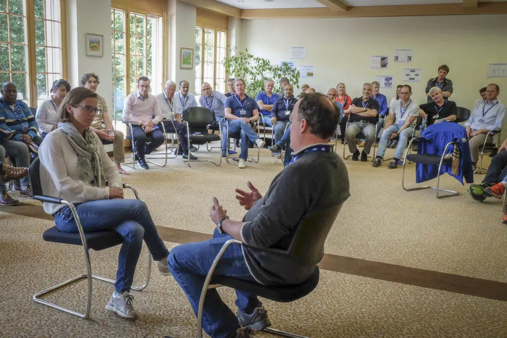 IMD executive education participants engaged in a group discussion during an interactive leadership workshop session. - IMD Business School