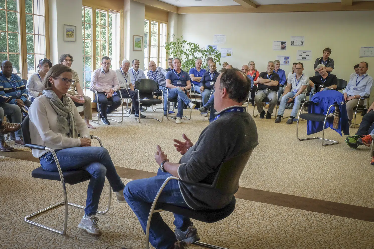 IMD executive education participants engaged in a group discussion during an interactive leadership workshop session. - IMD Business School