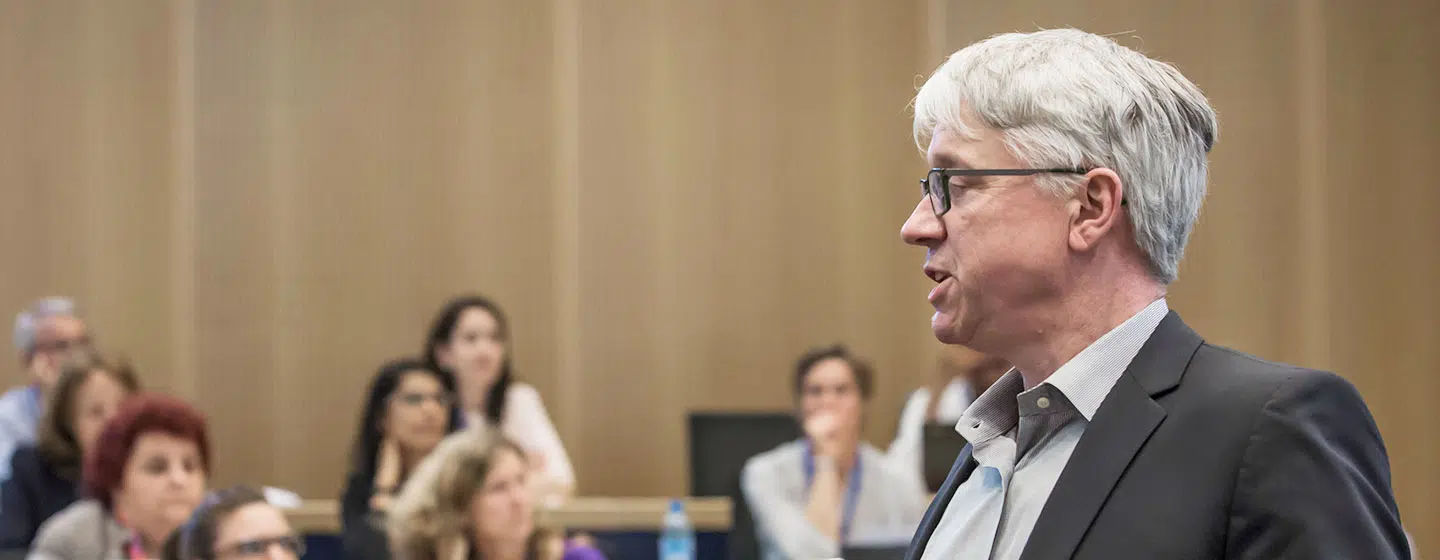Michael Watkins, IMD executive leadership program director, speaking during an executive education session with participants listening in the background. - IMD Business School