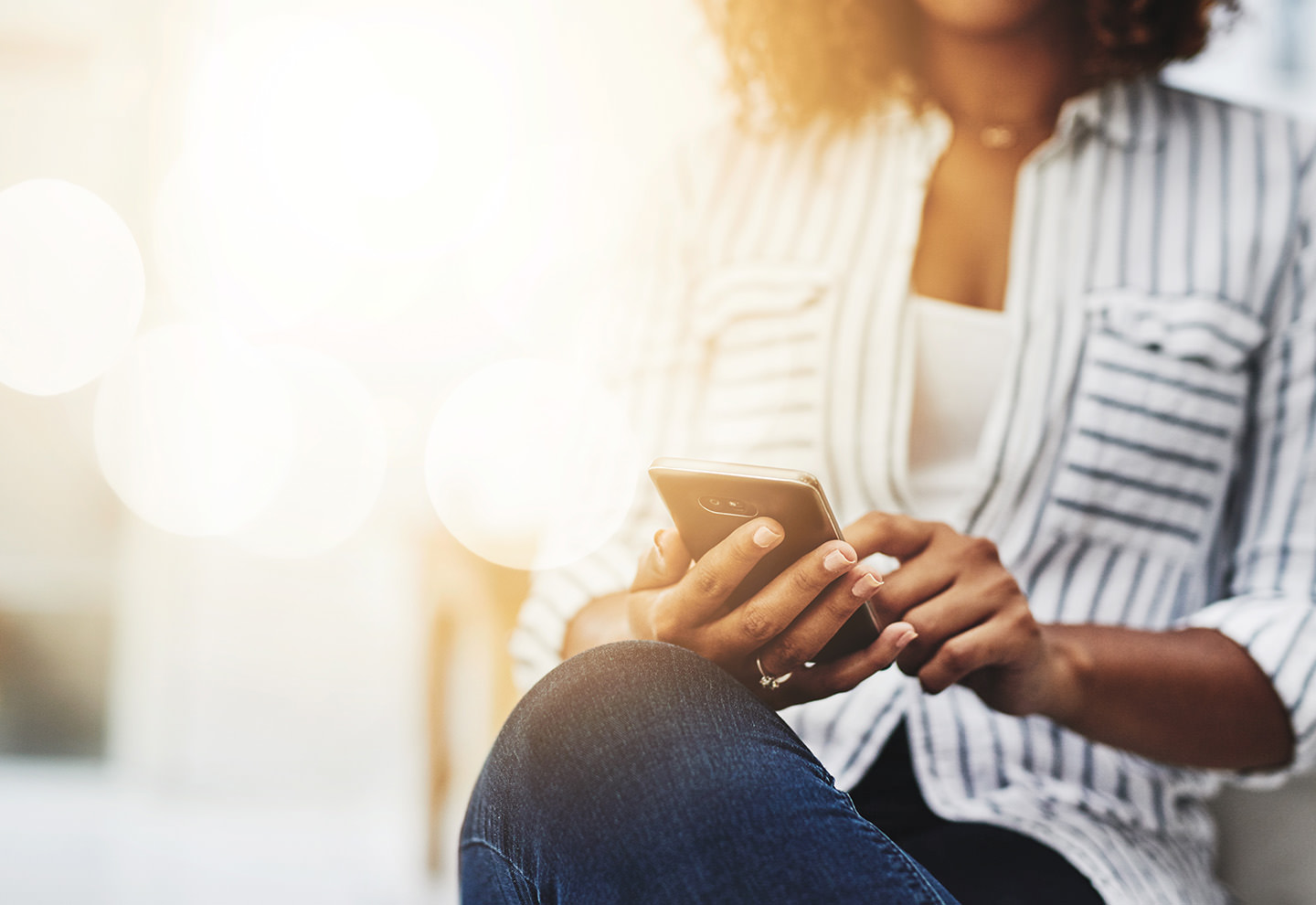 girl downloading app on iPhone - IMD Business School