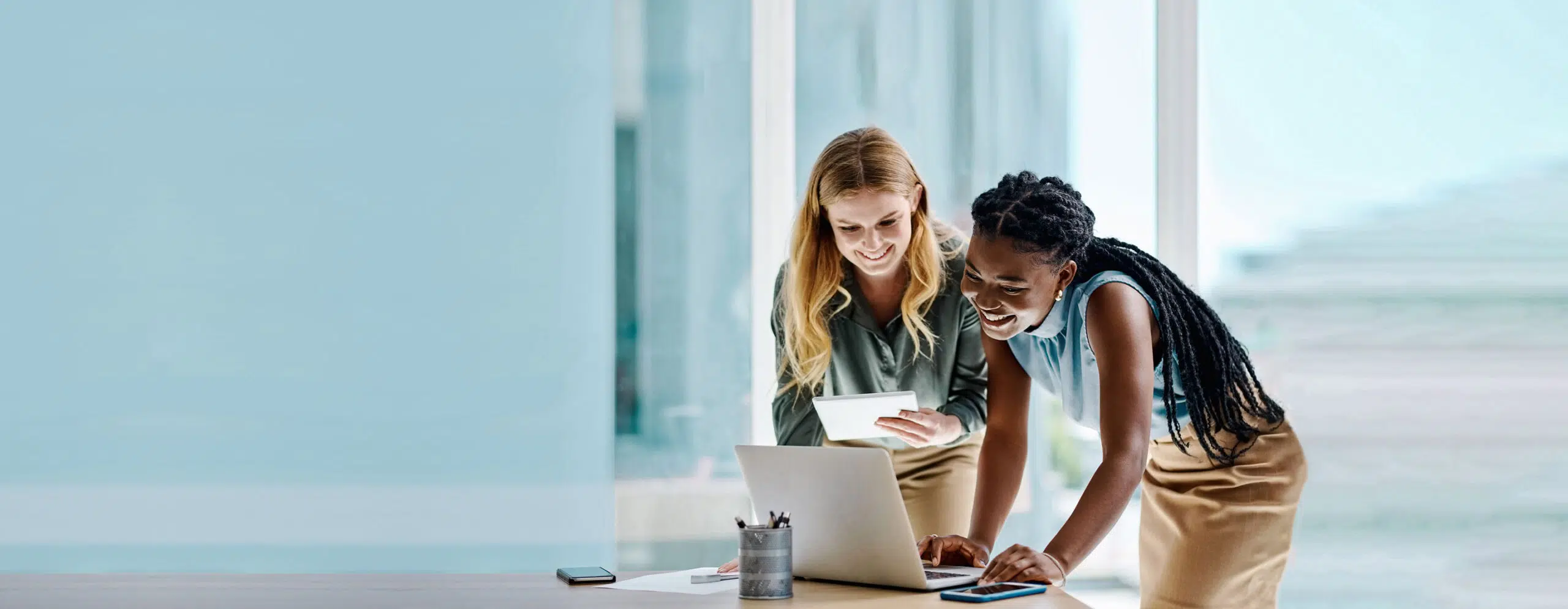 Two women from different ethnic backgrounds collaborate together - IMD Business School