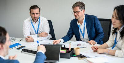 IMD participants discussing around a table - IMD Business School