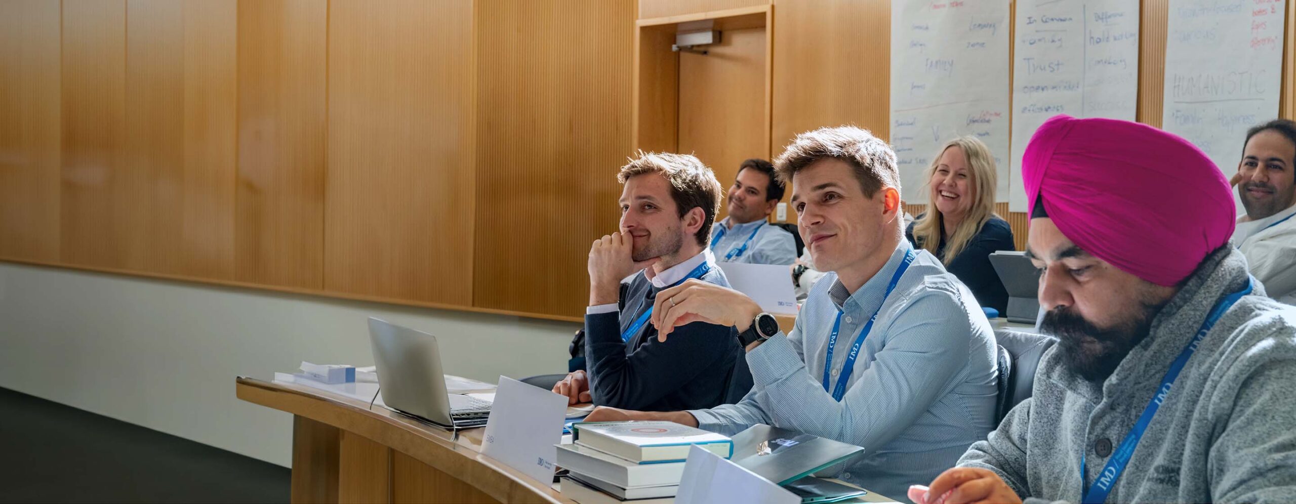 IMD EMBA students networking and taking numbers - IMD Business School