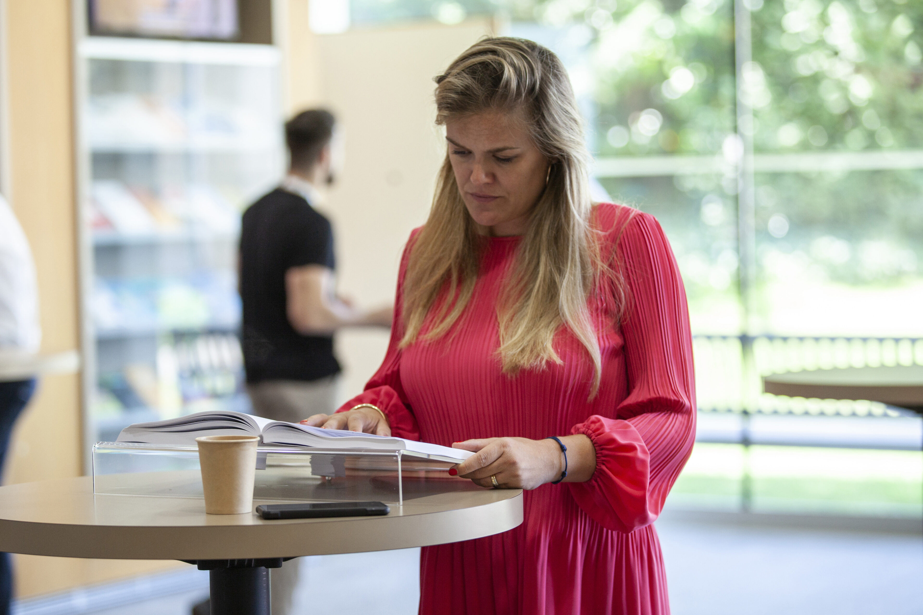 Participant consulting a book IMD OWP 2022 30 June - IMD Business School