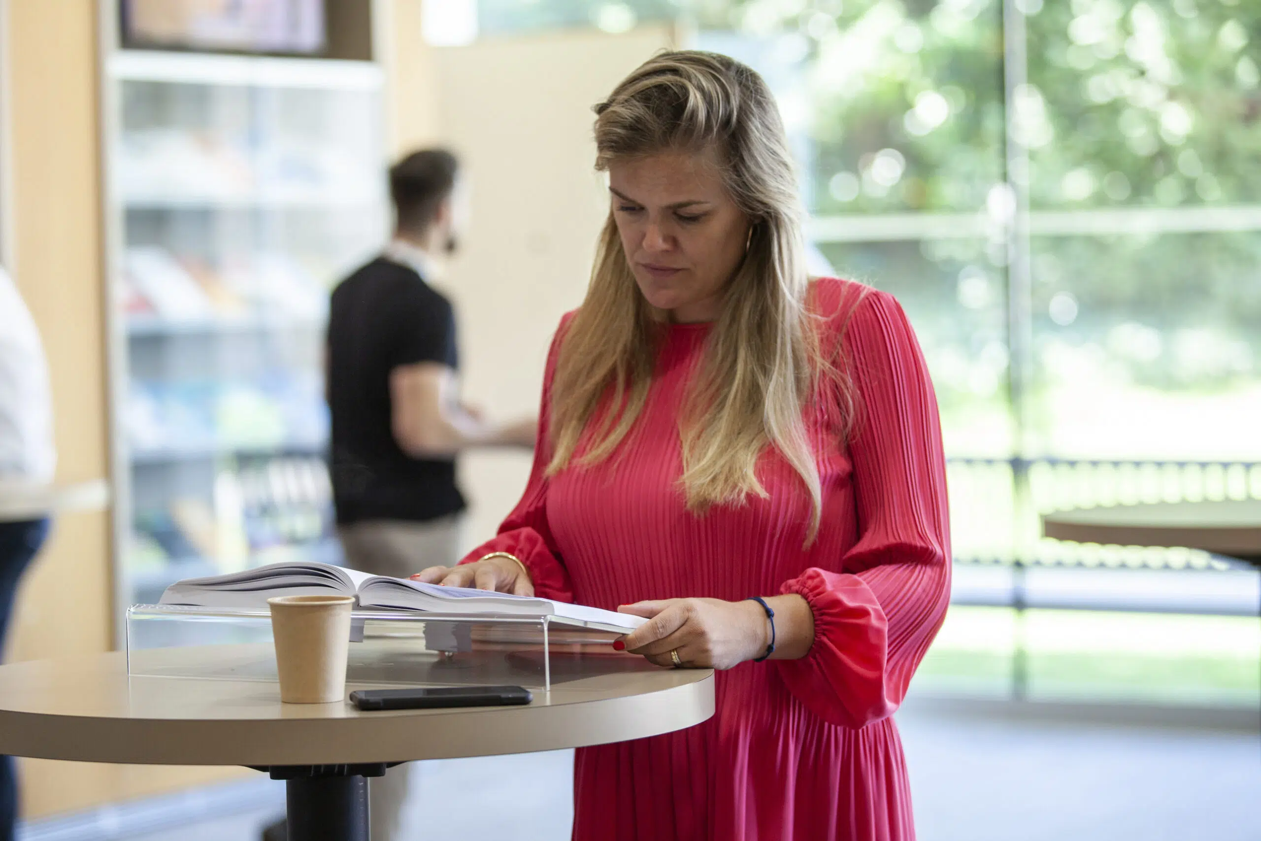 Participant consulting a book IMD OWP 2022 30 June - IMD Business School