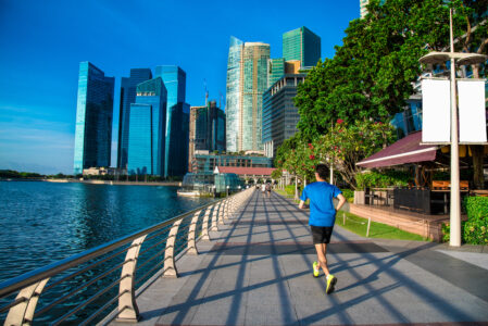 Healthy man running exercise in the morning in Marina Bay Sand park - IMD Business School