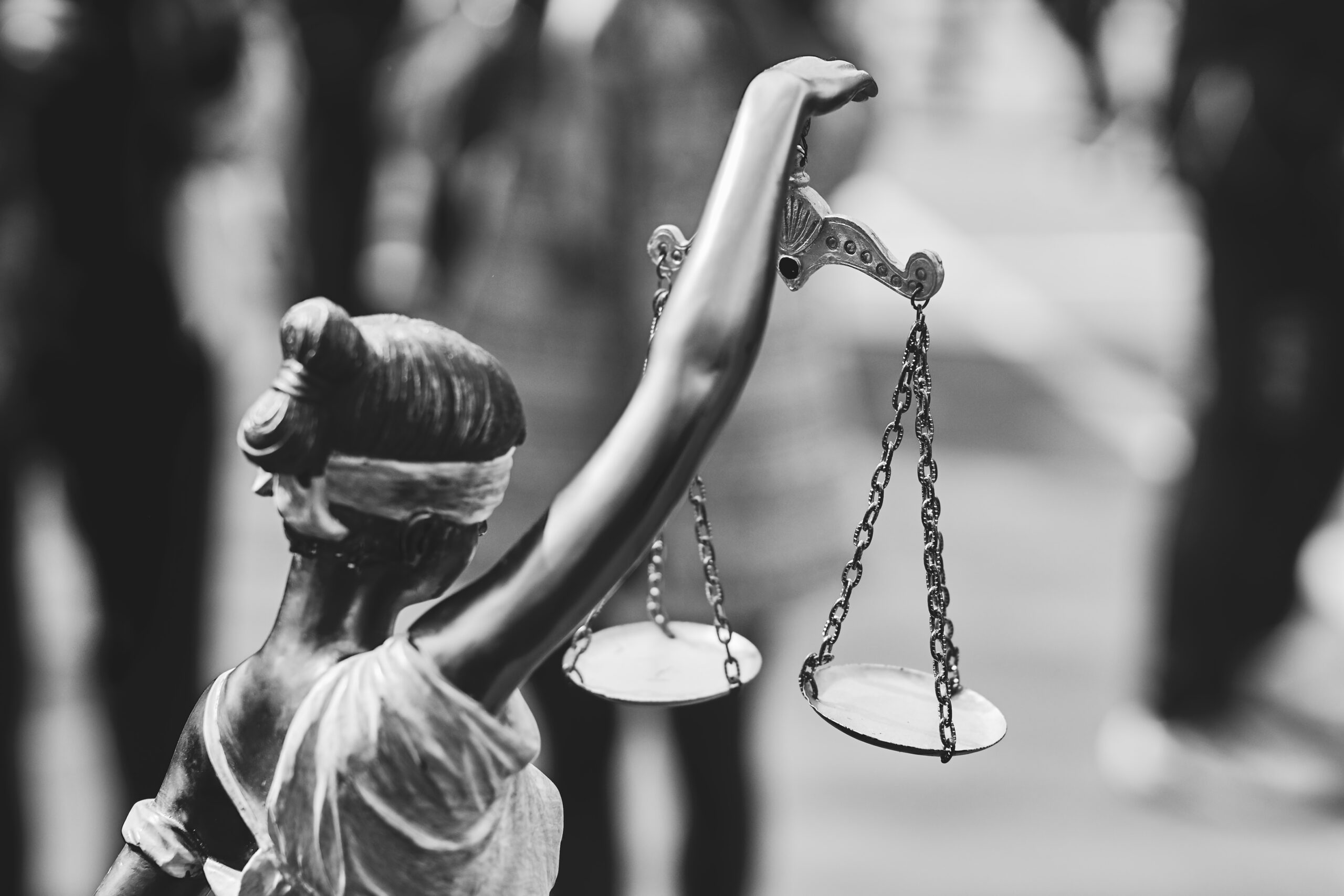 Rear view of themis statue with balance scales in black and whit - IMD Business School