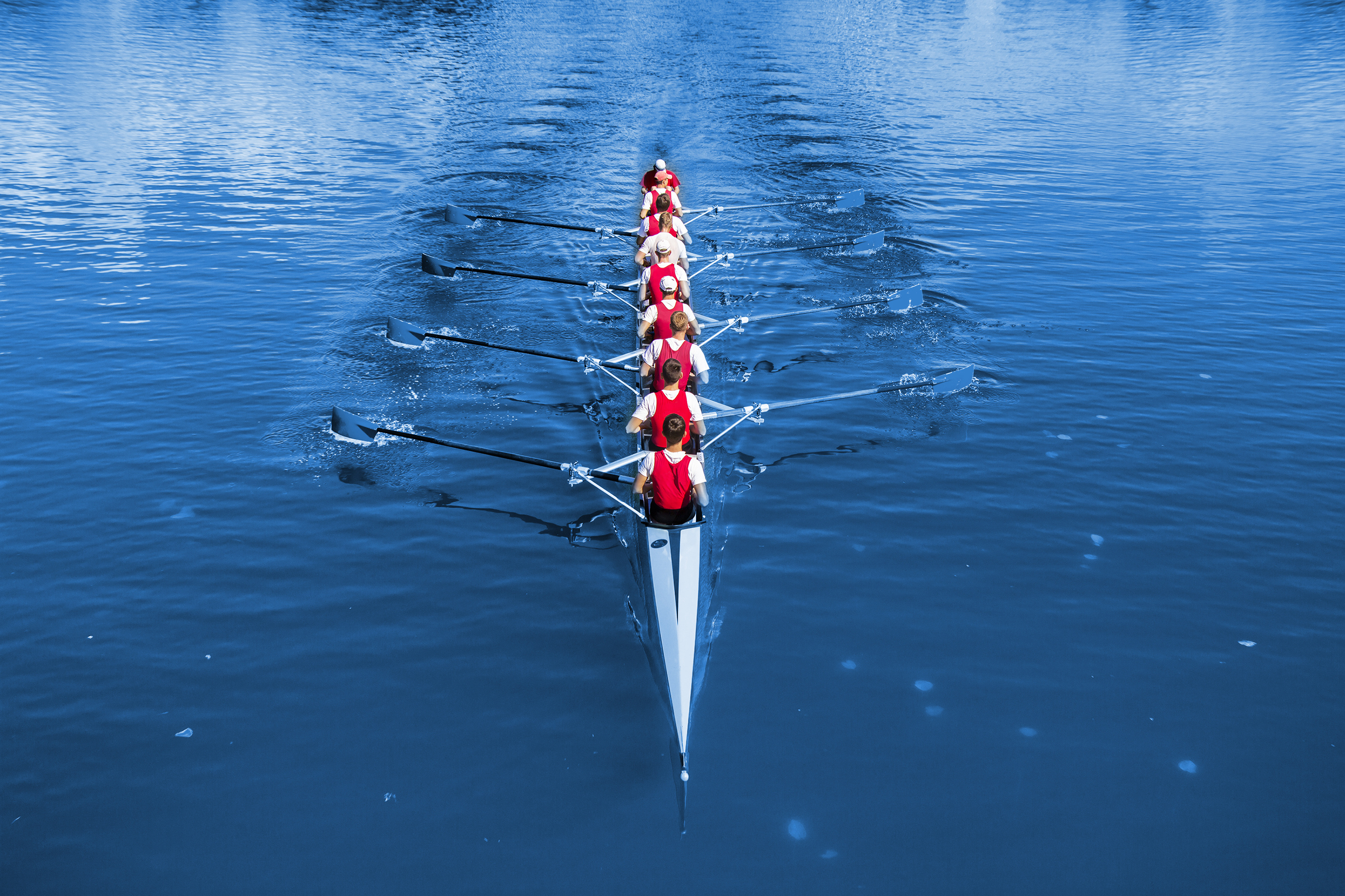 Boat coxed eight Rowers rowing on the blue lake Classic Blue Pa