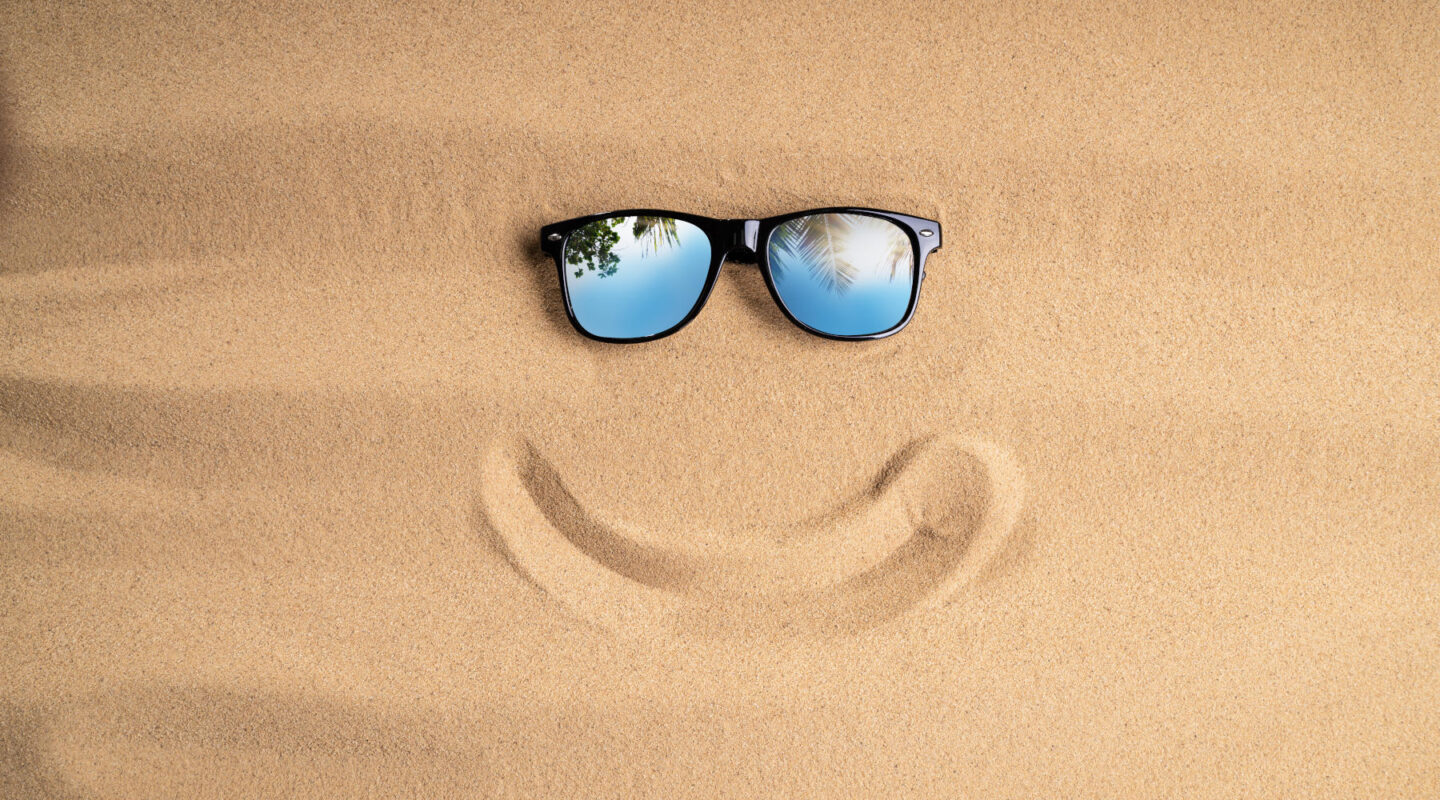 Sunglasses And Smiling Line On Sand At Beach