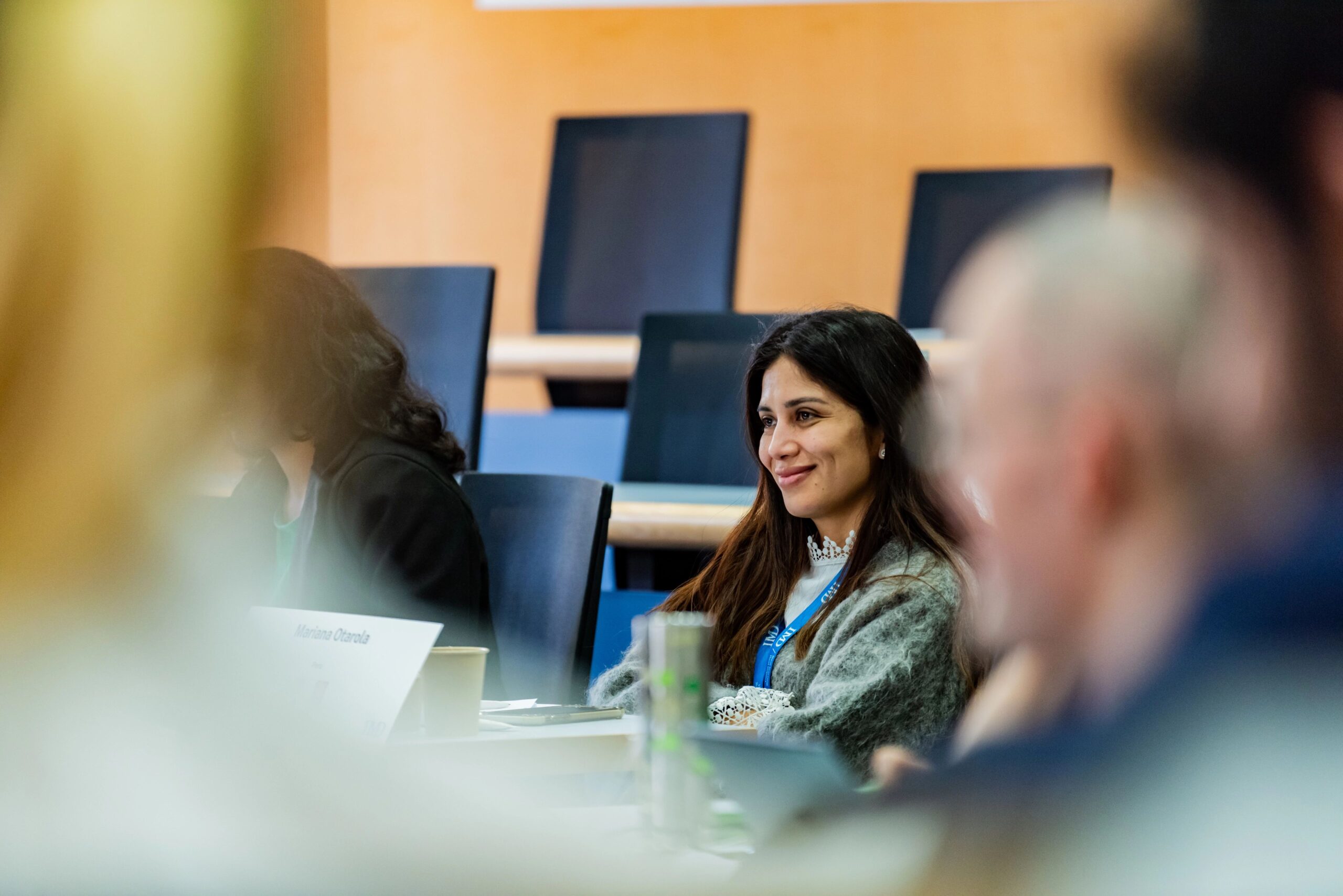 MBA student sits in class learning real leadership skills through real experiential learning. - IMD Business School