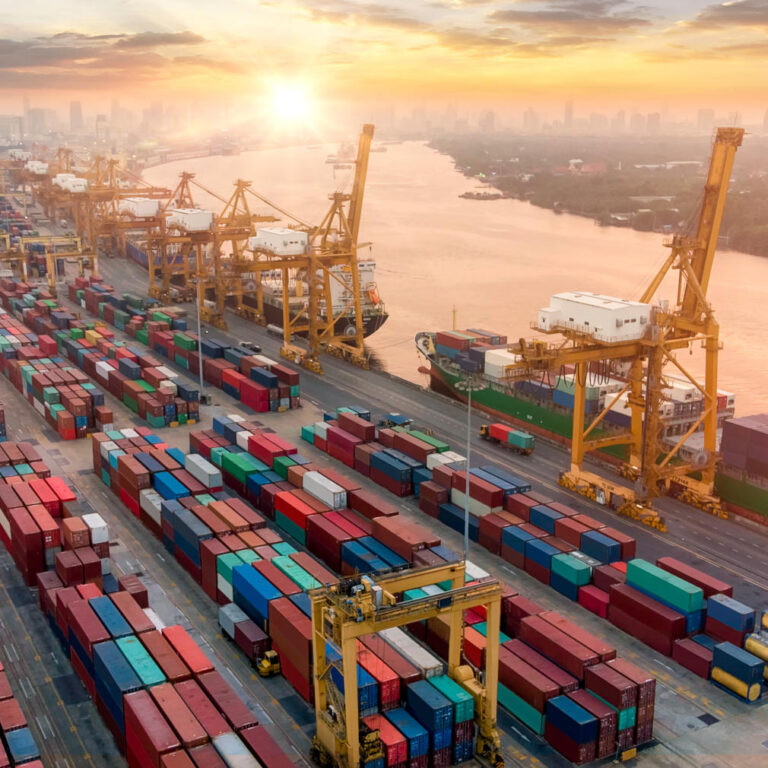 Aerial view and top view cargo plane flying above ship port in the export and import business and logistics international goods. Shipping cargo to harbor by crane
