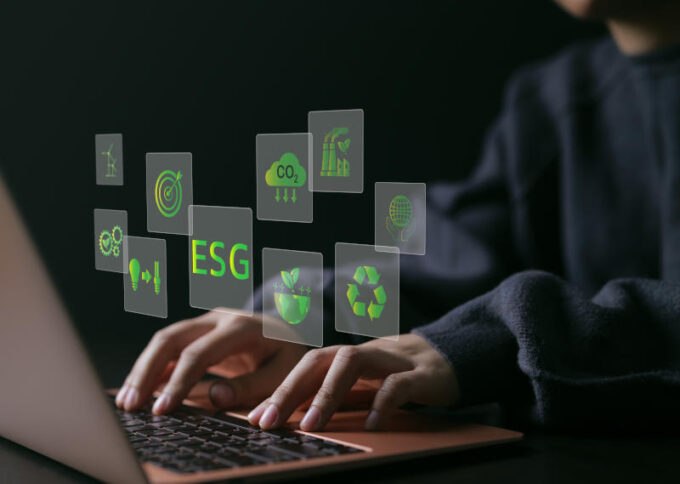 ESG environmental social governance investment business concept. woman uses a computer to analyze ESG data. ESG icons pop up on virtual screen in business sustainability investment strategy concept.