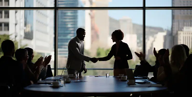 Business people clapping and handshake for deal in boardroom merger and proud of company win Partners applause and thank you for teamwork or success contract and united in global acquisition - IMD Business School