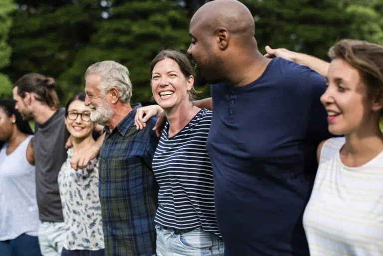 Cheerful diverse people together in the park - IMD Business School
