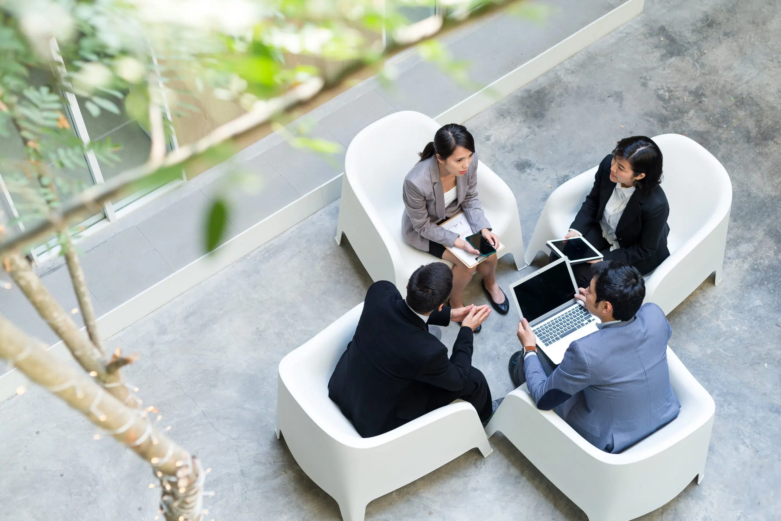 Top view of business people having discussion together - IMD Business School