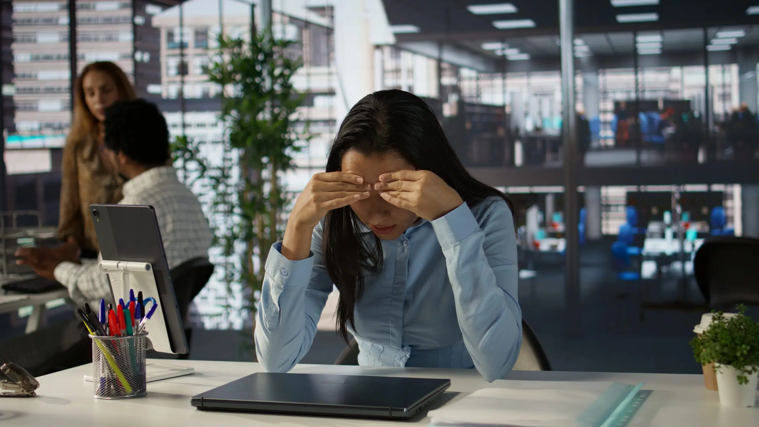 Overwhelmed indian businesswoman faces a tough day at the office, dealing with pressure and anxiety. Stressed tired employee suffers from mental exhaustion due to corporate tasks. Camera B. - IMD Business School