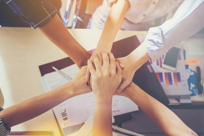 Team work concept Business people joining hands