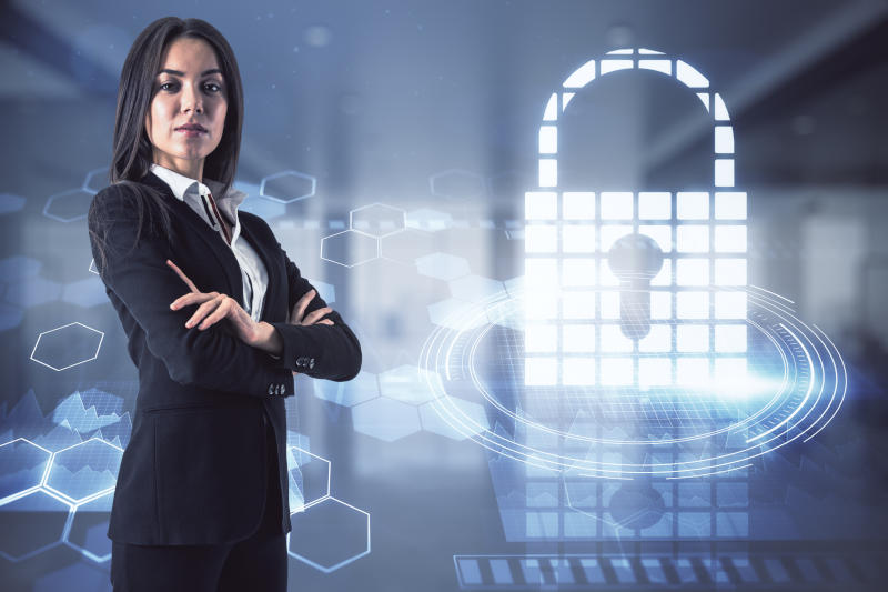 Attractive young european businesswoman and abstract digital padlock hologram on blurry office interior background. Technology and protection concept