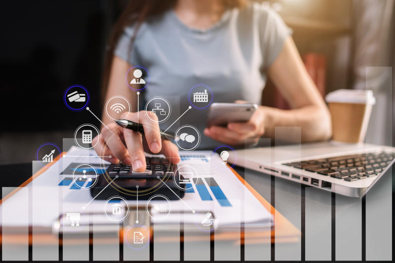 Female businessman calculates financials with graph paper on the