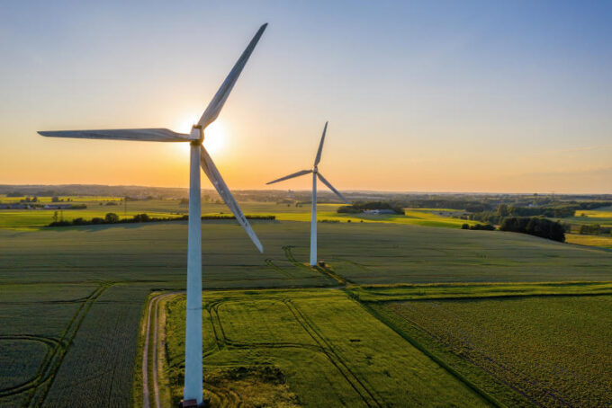 Wind turbines that produce electricity built on a field in Skan