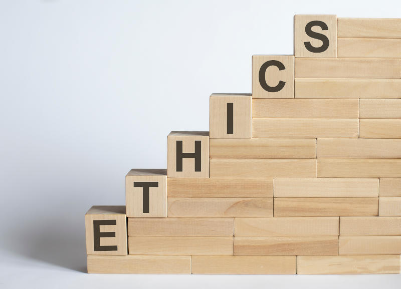 Work strategy on the wood blocks ETHICS on the white background