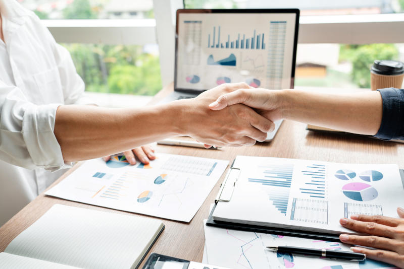 Business handshake after agreement meeting or negotiation finishing up dealing project partnership approval and deal concept