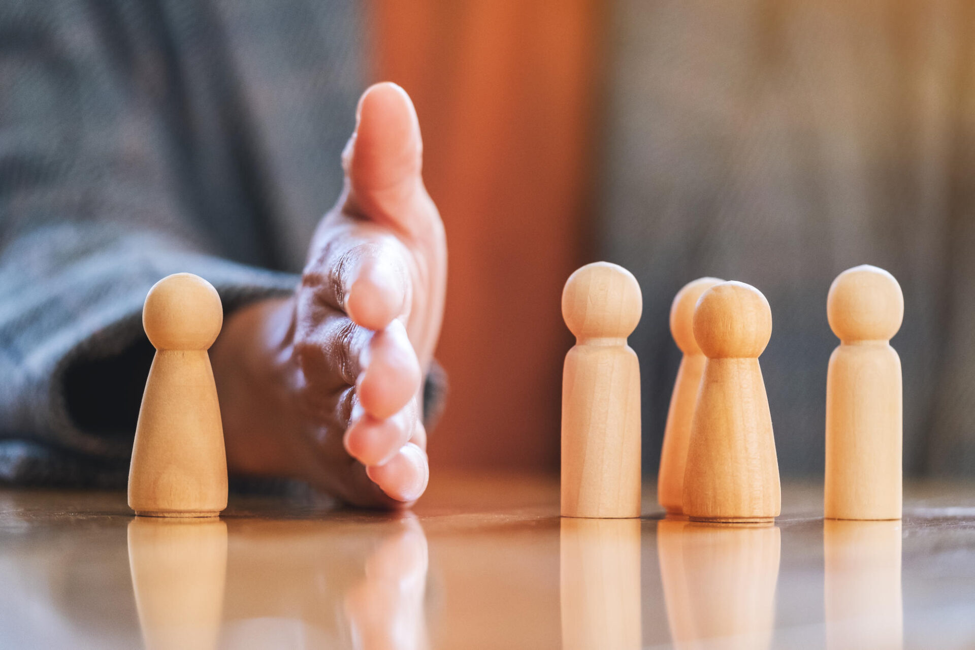 Concept image of a businessman separate one wooden people from a group