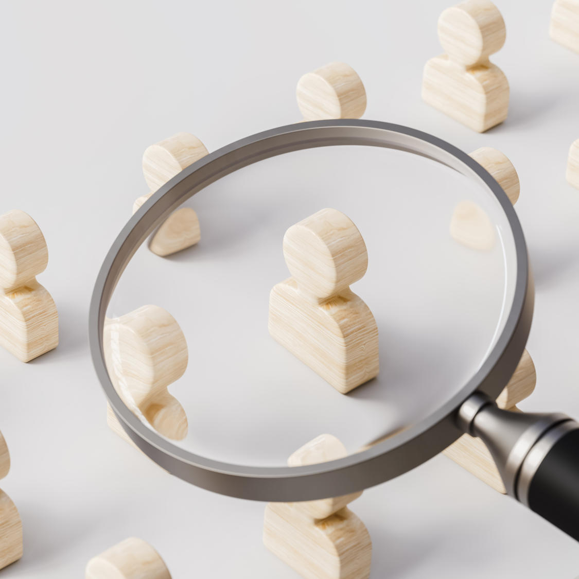 Magnifying glass searches for the best option in job profiles on white stage human resources