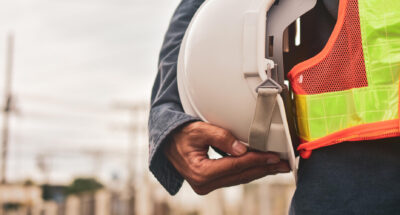 Engineer holding white helmet safety hard hat copy spec