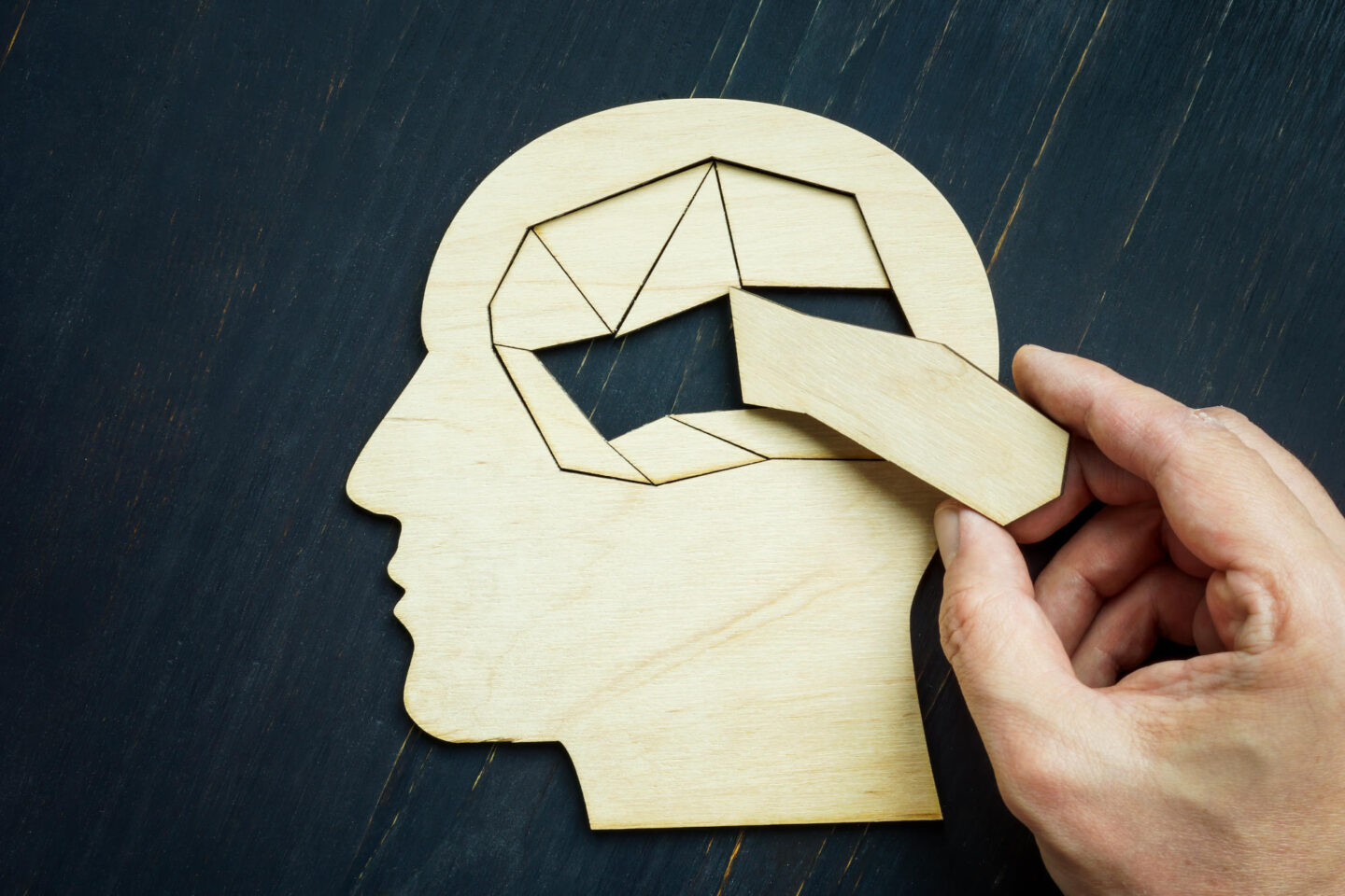 Memory loss and problems with brain The hand puts the last piece of the puzzle
