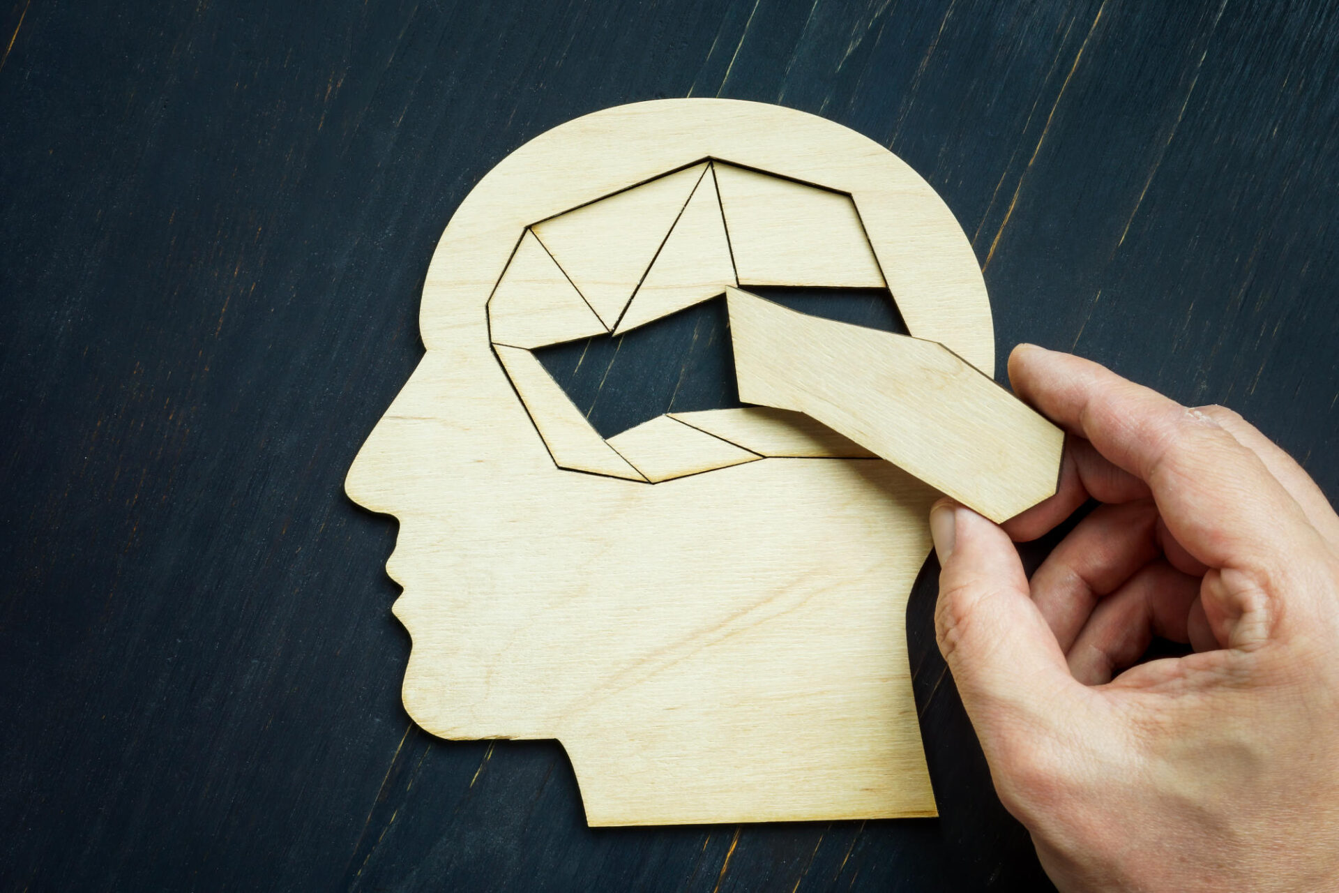 Memory loss and problems with brain The hand puts the last piece of the puzzle