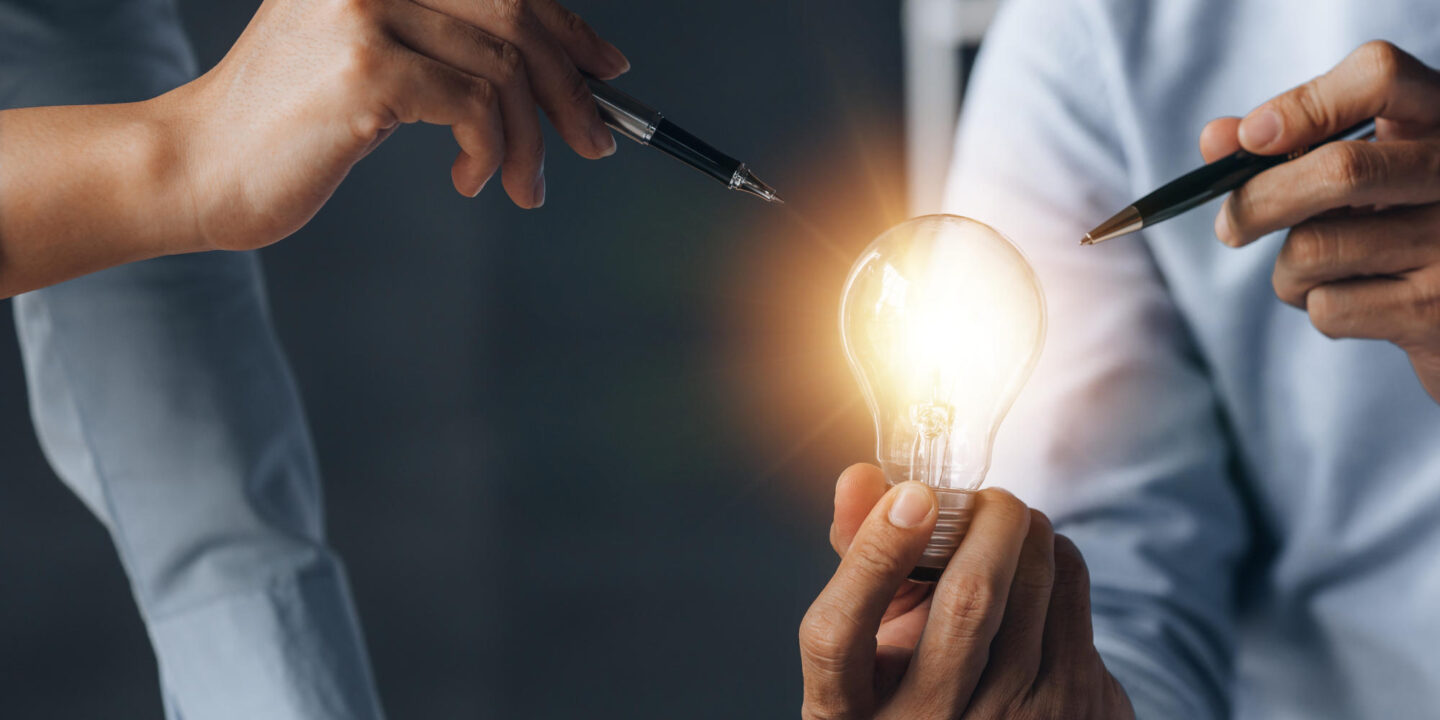 Businessman holds a glowing lamp Creative new idea Innovation brainstorming strategizing to make the business grow and be profitable Concept execution strategy planning and profit management