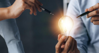 Businessman holds a glowing lamp Creative new idea Innovation brainstorming strategizing to make the business grow and be profitable Concept execution strategy planning and profit management
