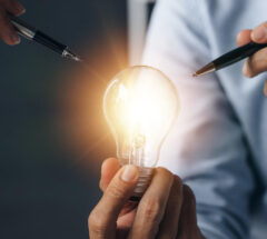 Businessman holds a glowing lamp Creative new idea Innovation brainstorming strategizing to make the business grow and be profitable Concept execution strategy planning and profit management