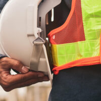 Engineer holding white helmet safety hard hat copy spec
