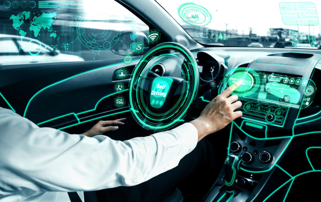 Self-driving autonomous car with relaxed young man sitting at driver seat is driving on busy highway road in the city Concept of machine learning artificial intelligence and augmented reality - IMD Business School