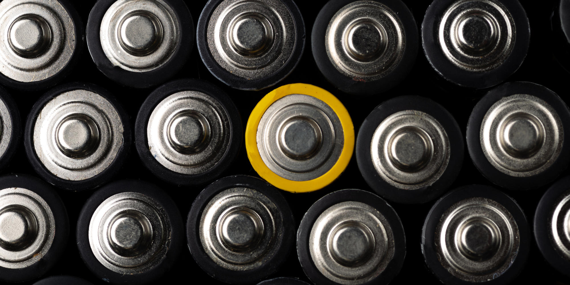 Energy abstract background of batteries Close up top view on rows of selection of AA batteries Alkaline battery aa size Many aa batteries